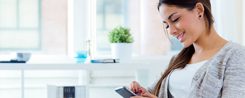 Hispanic woman checking her phone