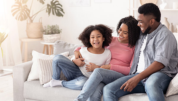 family laughing on the couch